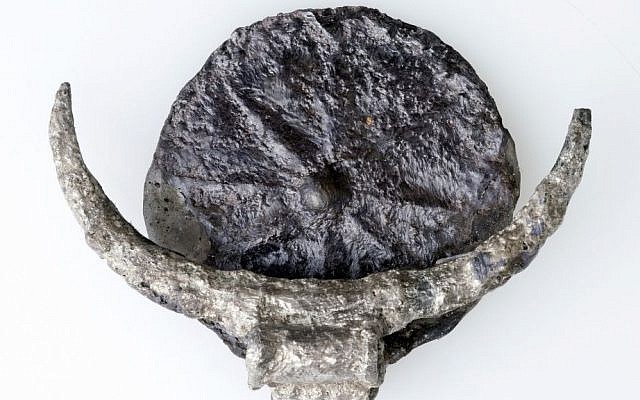 Medallion made up of a silver disc with an engraving of an eight pointed star that was discovered in Tel Gezer in November 2016. (CLARA AMIT/IAA)