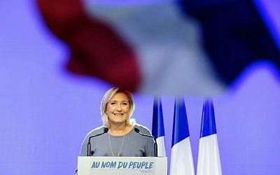 Marine Le Pen delivering a speech on stage behind a French national flag during the FN's summer congress in Frejus, southern France on September 18, 2016. (AFP / Franck PENNANT)