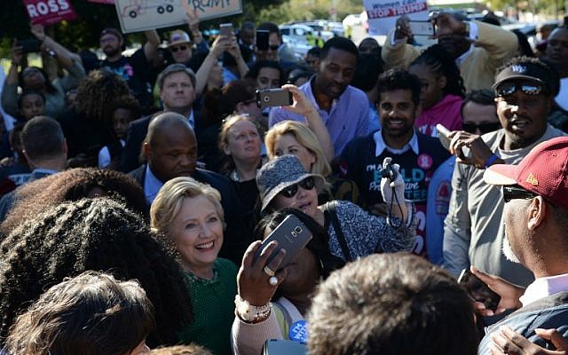 Democratic presidential nominee Hillary Clinton meets with voters during an impromptu stop at an early voting center at Chavis Community Center on October 23, 2016 in Raleigh, North Carolina. (AFP PHOTO / Robyn BECK)