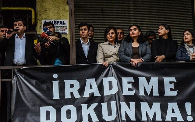 Pro-Kurdish People's Domocratic Party leader Selhattin Demirtas (L) stands behind a banner reading 'Do not touch my will' as he addresses a demonstration in Diyarbakir on October 28, 2016 following the arrest of the two co-mayors. (AFP/Ilyas Akengin) Pro-Kurdish People's Domocratic Party leader Selhattin Demirtas (L) stands behind a banner reading 'Do not touch my will' as he addresses a demonstration in Diyarbakir on October 28, 2016 following the arrest of the two co-mayors. (AFP/Ilyas Akengin)
