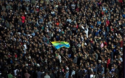 Protesters wave the Amazigh (Berber) flag as they shout slogans in the northern city of Al Hoceima on October 30, 2016, following the death of fishmonger Mouhcine Fikri, who was crushed to death on October 28 in a rubbish truck in Al Hoceima. (AFP PHOTO/FADEL SENNA)