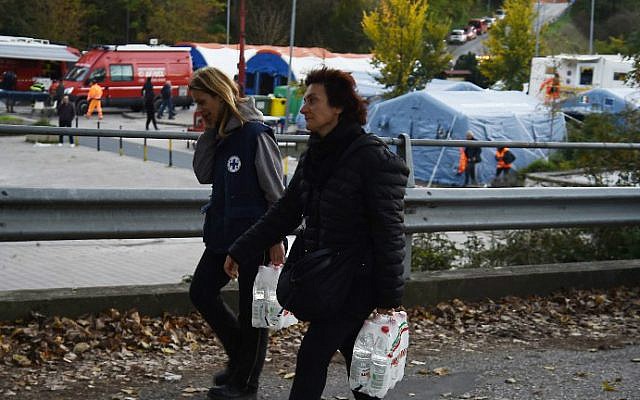 Residents carry packs of water bottles, on October 31, 2016 in Norcia, Italy a day after a 6.6 magnitude earthquake hit central Italy. (Filippo Monteforte/AFP)