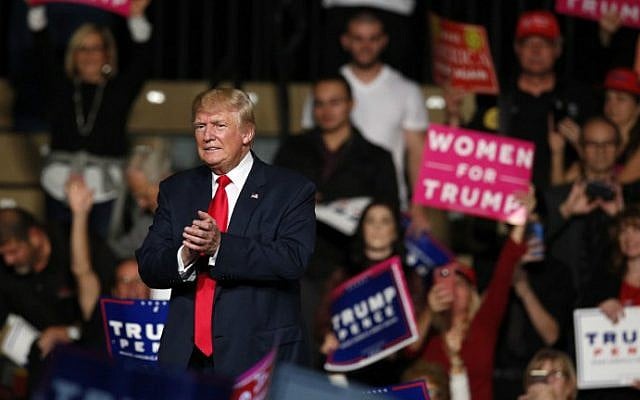 US Republican presidential candidate Donald Trump applauds after addressing supporters at Macomb Community College in Warren, Michigan on October 31, 2016. (Jeff Kowalsky/AFP)