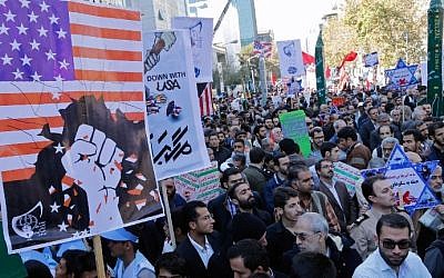 Iranians hold anti-America banners outside the former US embassy in the Iranian capital Tehran on November 3, 2016, during a demonstration marking the anniversary of its storming by student protesters that triggered a hostage crisis in 1979.  (AFP PHOTO / ATTA KENARE)