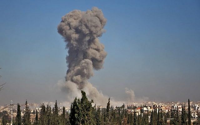 Smoke billows in the background on November 3, 2016, at an entrance to Aleppo during a rebel offensive to break a three-month siege of the opposition-held east of Syria's second city. ( AFP PHOTO / Omar haj kadour)