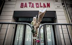This file photo taken on November 01, 2016 shows flowers tied to a fence outside the "Bataclan" concert hall, one of the targets of the November 13, 2015 terrorist attacks during which 130 people were killed and another 413 were wounded ( AFP PHOTO / PHILIPPE LOPEZ)