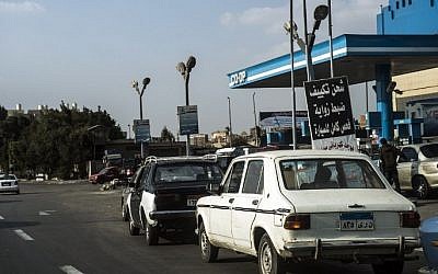 Cars queue at a petrol station in the Egyptian capital Cairo on November 4, 2016. The government announced an increase in fuel prices, with low grade petrol increasing by 50 percent to 2.35 pounds a liter while higher octane fuel rose by about one third to 3.5 pounds per liter. (Khaled Desouki/AFP)