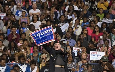 A supporter of US Republican presidential candidate Donald Trump stands up and shouts as US President Barack Obama speaks during a Hillary for America campaign event at Fayetteville State University in Fayetteville, North Carolina, November 4, 2016. (AFP/Jim Watson)