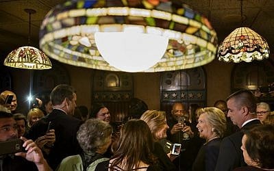 Democratic presidential nominee Hillary Clinton speaks with patrons at Miller's Bar on November 4, 2016 in Dearborn, Michigan. (AFP PHOTO / Brendan Smialowski)