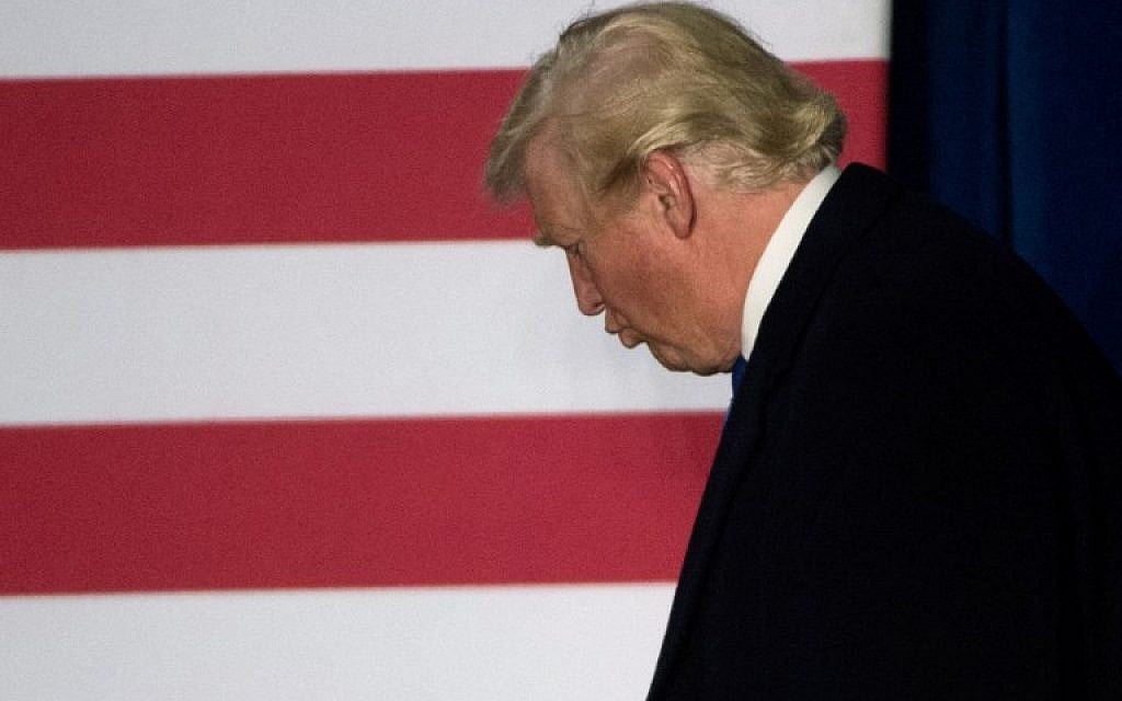 Republican presidential candidate Donald Trump walks off the stage after holding a rally at Loudoun Fairgrounds in Leesburg, Virginia, early in the morning on November 7, 2016. (AFP/MOLLY RILEY)