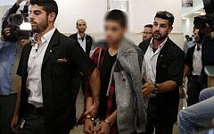 A Palestinian minor, who identity is under court-imposed gag order, convicted of the attempted murder of two Israelis in a stabbing in October 2015, leaves the District Court in Jerusalem after his sentencing hearing on November 7, 2016. (AFP /AHMAD GHARABLI)