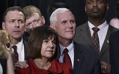 Republican vice presidential nominee Mike Pence and his wife Karen listen as his running mate Donald Trump addresses the final rally of his 2016 campaign at Devos Place in Grand Rapids, Michigan on November 7, 2016. (AFP PHOTO/MANDEL NGAN)