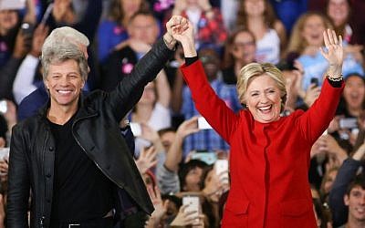 Hillary Clinton and Jon Bon Jovi gesture to the crowd inside the Reynolds Coliseum on the campus of North Carolina State University for the final campaign stop before election day, in Raleigh, North Carolina, on November 7, 2016. (AFP PHOTO / Logan Cyrus) Hillary Clinton and Jon Bon Jovi gesture to the crowd inside the Reynolds Coliseum on the campus of North Carolina State University for the final campaign stop before election day, in Raleigh, North Carolina, on November 7, 2016. (AFP PHOTO / Logan Cyrus)