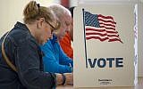People cast their votes for US president, November 8, 2016, at Centreville High School, in Centreville, Virginia. (AFP Photo/Paul J. Richards)
