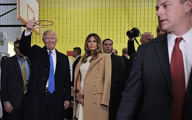 Republican presidential nominee Donald Trump gives the thumbs-up after he and his wife Melania (R) submitted their ballots at a polling station in a school during the 2016 presidential elections on November 8, 2016 in New York. (AFP PHOTO / MANDEL NGAN)