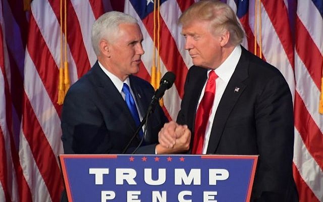 Republican president-elect Donald Trump (R) shakes hands with his running mate Mike Pence at an election victory celebration the New York Hilton Midtown in New York on November 9, 2016. (AFP PHOTO/JIM WATSON) Republican president-elect Donald Trump (R) shakes hands with his running mate Mike Pence at an election victory celebration the New York Hilton Midtown in New York on November 9, 2016. (AFP PHOTO/JIM WATSON)