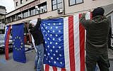 Residents of Sevnica, hometown of Melania Trump, wife of Republican presidential elect Donald Trump, hang a US flag as they celebrate the victory of Donald Trump in the race for the White House in Sevnica, Slovenia, November 9, 2016. (AFP/Jure MAKOVEC)