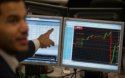 Illustrative: A trader points to a the trading terminal screen showing the S&P 500 Index. (AFP PHOTO / DANIEL LEAL-OLIVAS)