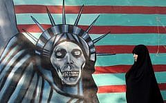 An Iranian woman walks past a mural on the wall of the former US embassy in the Iranian capital Tehran, November 9, 2016. (AFP/Atta Kenare)