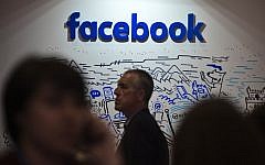 People pass by the stand of Facebook during the Web Summit at Parque das Nacoes, in Lisbon on November 9, 2016. ( AFP PHOTO / PATRICIA DE MELO MOREIRA)