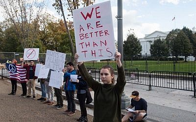 Protestors hold signs against US President-elect Donald Trump on November 9, 2016 in front of the White House in Washington, DC. (AFP PHOTO / NICHOLAS KAMM)
