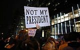 A man holds a poster as he takes part in a protest against President-elect Donald Trump in New York City on November 9, 2016. (KENA BETANCUR / AFP)