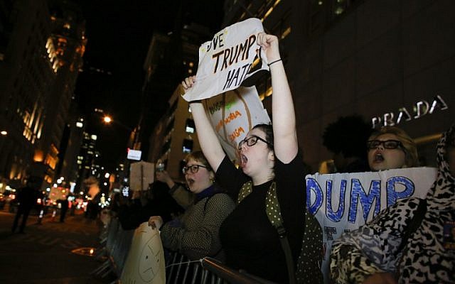 People take part in a protest against President-elect Donald Trump in front of Trump Tower in New York on November 10, 2016. (AFP/Kena Betancur) People take part in a protest against President-elect Donald Trump in front of Trump Tower in New York on November 10, 2016. (AFP/Kena Betancur)