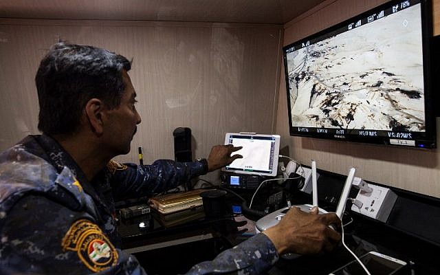 Lieutenant Colonel Hussein Hussein of the Iraqi police operates a drone, inside an armoured vehicle turned into a drone control center, near the village of Arbid, on the southern Mosul front, November 12, 2016. (AFP/Achilleas ZAVALLIS)