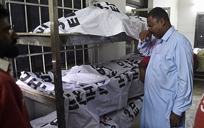 A Pakistani man mourns the death of relative in a mortuary in Karachi on November 12, 2016, following the arrival of those killed in bombing at a Sufi shrine. (AFP PHOTO / RIZWAN TABASSUM) A Pakistani man mourns the death of relative in a mortuary in Karachi on November 12, 2016, following the arrival of those killed in bombing at a Sufi shrine. (AFP PHOTO / RIZWAN TABASSUM)