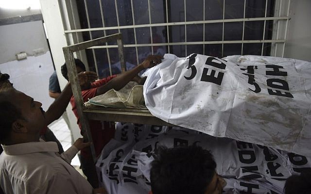 People identify bodies at a mortuary in Karachi on November 12, 2016, following a bombing at a Sufi shrine. (AFP PHOTO / RIZWAN TABASSUM) People identify bodies at a mortuary in Karachi on November 12, 2016, following a bombing at a Sufi shrine. (AFP PHOTO / RIZWAN TABASSUM)