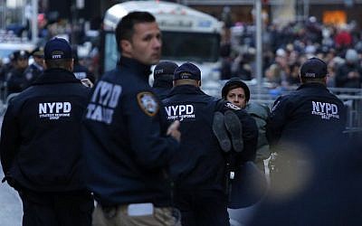 A woman is arrested after she jumped the fence during a protest against US President-elect Donald Trump in front of Trump Tower on November 12, 2016 in New York. (AFP PHOTO / KENA BETANCUR)