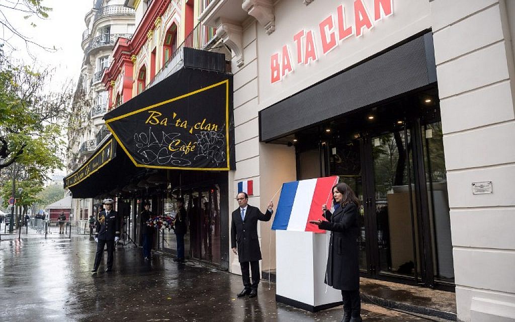 French President Francois Hollande (L) and Paris' Mayor Anne Hidalgo unveil a commemorative plaque at the Bataclan concert hall in Paris on November 13, 2016, during a ceremony marking the first anniversary of the Paris terror attacks.  (AFP PHOTO / POOL / Christophe Petit Tesson)