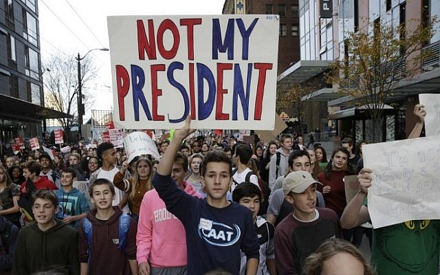 Local students and their supporters march during a walkout protest against US President-elect Donald Trump in Seattle, Washington on November 14, 2016. (AFP PHOTO / Jason Redmond) Local students and their supporters march during a walkout protest against US President-elect Donald Trump in Seattle, Washington on November 14, 2016. (AFP PHOTO / Jason Redmond)