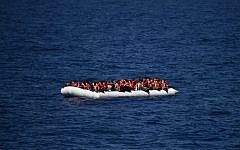 This file photo taken on May 24, 2016 shows African refugees waiting on a rubber boat to be rescued during an operation at sea, on May 24, 2016. (AFP/Gabriel Bouys)