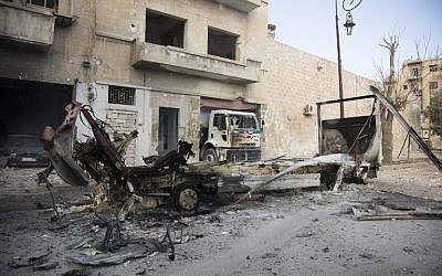 The wreckage of vehicles is seen outside a civil defence center in Aleppo's rebel-held neighborhood of Bab al-Nayrab on November 19, 2016, following recent government air strikes. (AFP PHOTO/KARAM AL-MASRI)