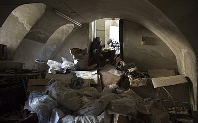 A member of the Syrian civil defense, known as the White Helmets, takes shelter in the basement of an old building during shelling in Aleppo's rebel-held neighborhood of Bab al-Nayrab on November 19, 2016. (AFP/Karam Al-Masri)
