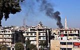Smoke billows in the government-held side of west Aleppo, on November 20, 2016, following reported rocket fire by the opposition forces that hold the eastern part of the city. (AFP PHOTO/GEORGE OURFALIAN)