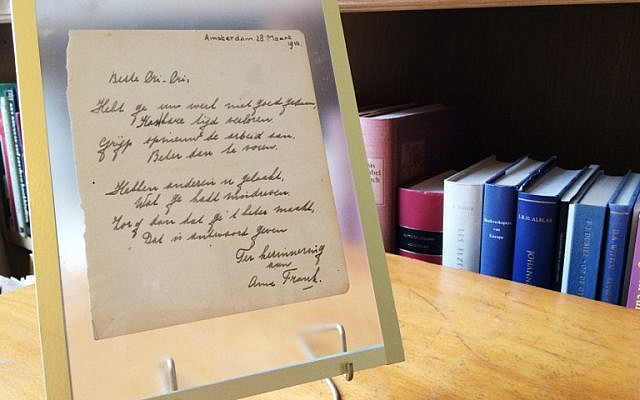 This photo taken on November 21, 2016 at the Bubb Kuyper auction house in Haarlem shows a rare handwritten poem by Anne Frank, penned shortly before she went into hiding from the Nazis, addressed to "Cri-Cri" or Christiane van Maarsen, signed by the Jewish teenager and dated March 28, 1942. (AFP PHOTO/Maude BRULARD) This photo taken on November 21, 2016 at the Bubb Kuyper auction house in Haarlem shows a rare handwritten poem by Anne Frank, penned shortly before she went into hiding from the Nazis, addressed to "Cri-Cri" or Christiane van Maarsen, signed by the Jewish teenager and dated March 28, 1942. (AFP PHOTO/Maude BRULARD)