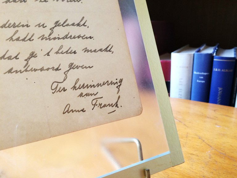 This photo taken on November 21, 2016 at the Bubb Kuyper auction house in Haarlem shows a rare handwritten poem by Anne Frank, penned shortly before she went into hiding from the Nazis, addressed to "Cri-Cri" or Christiane van Maarsen, signed by the Jewish teenager and dated March 28, 1942. (AFP PHOTO / Maude BRULARD) This photo taken on November 21, 2016 at the Bubb Kuyper auction house in Haarlem shows a rare handwritten poem by Anne Frank, penned shortly before she went into hiding from the Nazis, addressed to "Cri-Cri" or Christiane van Maarsen, signed by the Jewish teenager and dated March 28, 1942. (AFP PHOTO / Maude BRULARD)