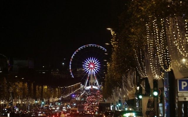 A photo taken on November 21, 2016 shows La Grande Roue ferris wheel in Paris after the Christmas lights of the Champs Elysees avenue were officially switched on during a ceremony. (AFP PHOTO / GEOFFROY VAN DER HASSELT) A photo taken on November 21, 2016 shows La Grande Roue ferris wheel in Paris after the Christmas lights of the Champs Elysees avenue were officially switched on during a ceremony. (AFP PHOTO / GEOFFROY VAN DER HASSELT)