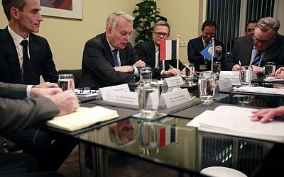 French Foreign Minister Jean-Marc Ayrault (C) takes part in a meeting with Ahmet Uzumcu (unseen), director general of the Organisation for the Prohibition of Chemical Weapons (OPCW) during his visit of the ICC (International Criminal Court) in The Hague on November 21, 2016.( AFP PHOTO / Anoek de Groot)