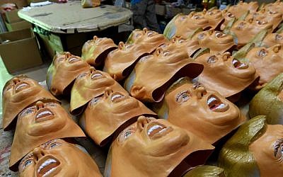 This picture taken on November 22, 2016 shows employees producing rubber masks of US President-elect Donald Trump at the Ogawa Studios mask factory in Saitama, north of Tokyo. (AFP PHOTO / TOSHIFUMI KITAMURA)