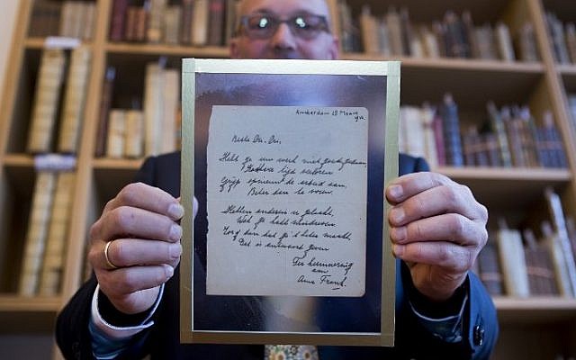 A man shows a handwritten poem by Anne Frank, written shortly before she went into hiding from the Nazis, at the auction Bubb Kuyper in Haarlem on November 22, 2016. (AFP PHOTO / ANP / Koen Suyk / Netherlands) A man shows a handwritten poem by Anne Frank, written shortly before she went into hiding from the Nazis, at the auction Bubb Kuyper in Haarlem on November 22, 2016. (AFP PHOTO / ANP / Koen Suyk / Netherlands)
