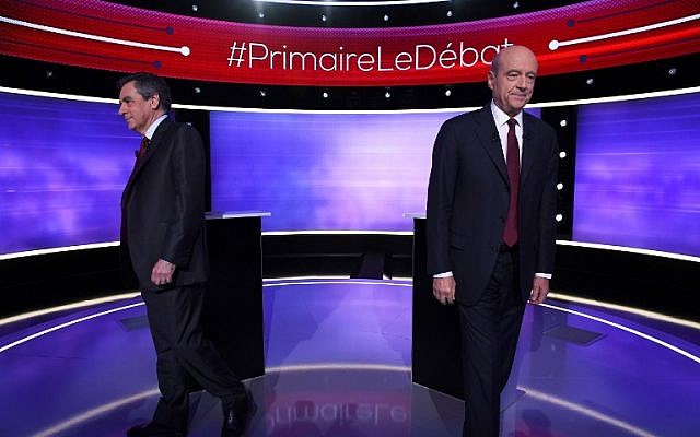 The two finalists in France's conservative presidential primary, Francois Fillon, left, and Alain Juppe, leave after posing for photographs prior to taking part in the first televised debate between the two remaining candidates for the right-wing Les Republicains (LR) party primaries in Paris, November 24, 2016. (AFP/POOL/Eric FEFERBERG)