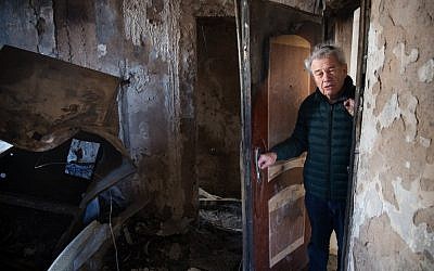 Haifa resident Aitan Shariel inspects the damage inside his house following a massive wildfire, on November 25, 2016. (AFP PHOTO/MENAHEM KAHANA)