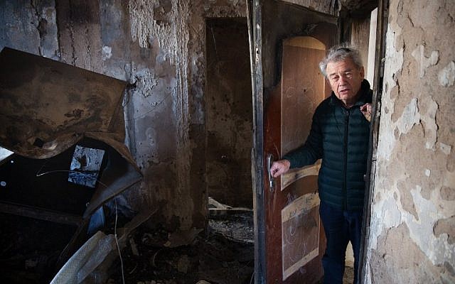 Haifa resident Aitan Shariel inspects the damage inside his house following a massive wildfire, on November 25, 2016. (AFP PHOTO/MENAHEM KAHANA) Haifa resident Aitan Shariel inspects the damage inside his house following a massive wildfire, on November 25, 2016. (AFP PHOTO/MENAHEM KAHANA)
