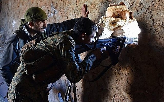 A fighter from the Syrian pro-government forces mans a riffle inside a damaged house in the recently recaptured village of Joubah during an offensive towards the area of Al-Bab in Aleppo province, on November 25, 2016. (AFP/George Ourfalian) A fighter from the Syrian pro-government forces mans a riffle inside a damaged house in the recently recaptured village of Joubah during an offensive towards the area of Al-Bab in Aleppo province, on November 25, 2016. (AFP/George Ourfalian)