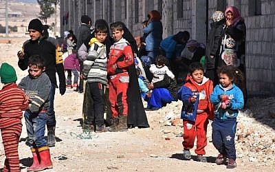 Syrian displaced families gather at a makeshit camp on November 27, 2016 in the government-held district of Jibreen in Aleppo, as civilians have fled the eastern part of the city in the past 24 hours as regime forces advance against rebel-held districts. (AFP/ GEORGE OURFALIAN)