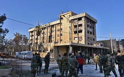 Syrian pro-government forces gather in front of a water pumping station in the Suleiman al-Halabi neighborhood of Aleppo on November 28, 2016, after they took control of the area from rebel fighters. (AFP PHOTO/GEORGE OURFALIAN)
