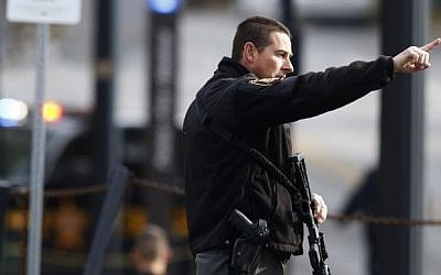 A law enforcement official motions for people to leave the area outside of a parking garage on the campus of Ohio State University as they respond to an active attack in Columbus, Ohio, on November 28, 2016. (AFP PHOTO / Paul Vernon) A law enforcement official motions for people to leave the area outside of a parking garage on the campus of Ohio State University as they respond to an active attack in Columbus, Ohio, on November 28, 2016. (AFP PHOTO / Paul Vernon)
